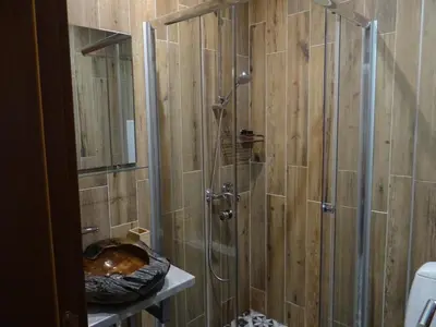 a shower with a glass door in a bathroom at Villa Camino in Sapareva Banya
