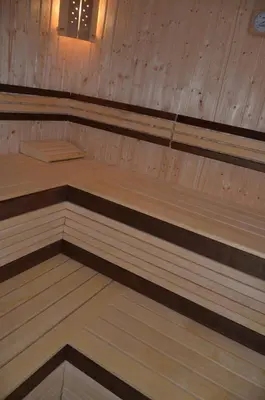 a wooden sauna with wooden floors and wooden walls at Leshtenski Rai Guest House in Leshten