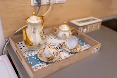 a tray with a tea pot and cups on a table at Karastoyanovi's Apartment in Sofia