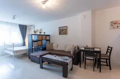 a living room with a couch and a table at Karastoyanovi's Apartment in Sofia