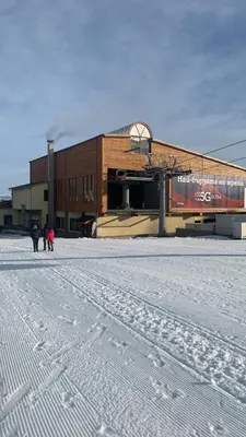 people walking in the snow in front of a building at Bansko Ski to Door Apartment in Bansko
