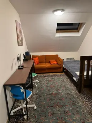 a living room with a couch and a table and a bed at Bansko Ski to Door Apartment in Bansko