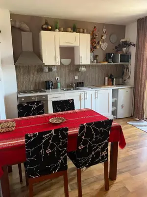 a kitchen with a table with a red counter top at Bansko ski apartment Mountain View Resort in Bansko