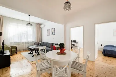 a living room with a white table and chairs at Spacious 3 Bedroom Home in Sofia's Top Center in Sofia