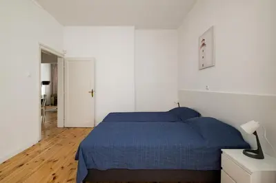 a bedroom with a blue bed and a white wall at Spacious 3 Bedroom Home in Sofia's Top Center in Sofia