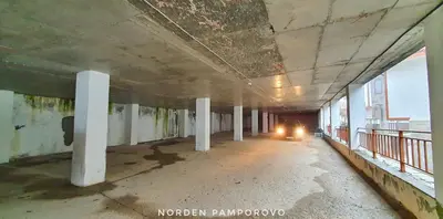 an empty hallway of an old building with columns at NordenPamporovo in Pamporovo
