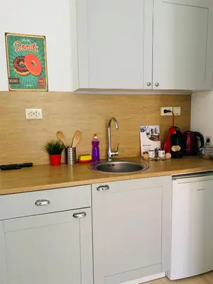 a kitchen with white cabinets and a sink at Studio Chalet 13, St John Park Bansko in Bansko