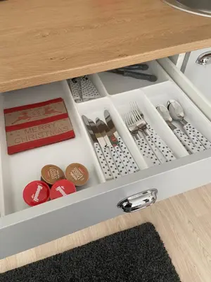 a drawer in a cabinet filled with dishes and utensils at Studio Chalet 13, St John Park Bansko in Bansko
