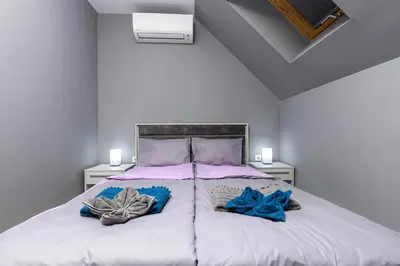 a bedroom with a large bed with two pillows on it at Beautiful 1BD Apartment with a Parking Spot by Flat Mаnager in Plovdiv