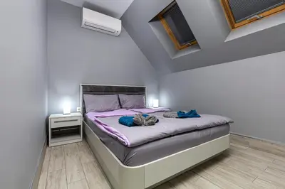 a bedroom with a bed with purple sheets and two lights at Beautiful 1BD Apartment with a Parking Spot by Flat Mаnager in Plovdiv