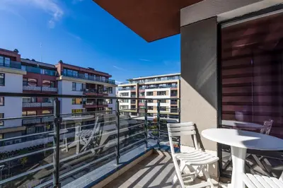 a balcony with chairs and a table on a building at Stylish 1BD flat with a Parking Spot by Flat Mаnager in Plovdiv