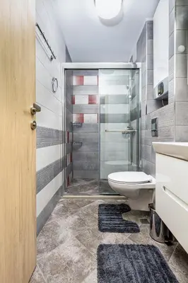 a bathroom with a toilet and a glass shower at Stylish 1BD flat with a Parking Spot by Flat Mаnager in Plovdiv