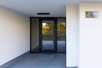 an entrance to a building with a glass door at Stylish 1BD flat with a Parking Spot by Flat Mаnager in Plovdiv