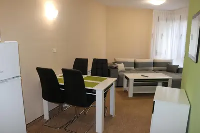 a living room with a table and chairs and a couch at Winter Аpartments Gerovi in Pamporovo