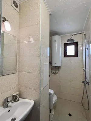 a bathroom with a shower and a sink and a toilet at Prime Apartments in Bansko