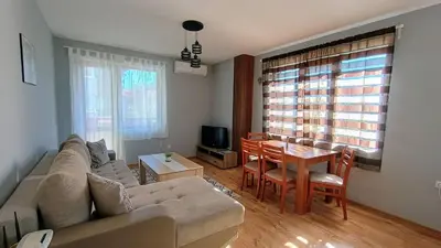 a living room with a couch and a table at Prime Apartments in Bansko