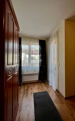 an empty living room with a large window at Prime Apartments in Bansko