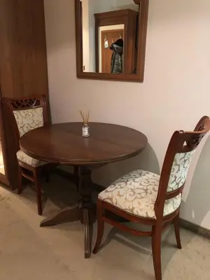 a wooden table with two chairs and a mirror at Luxury studio in Bansko