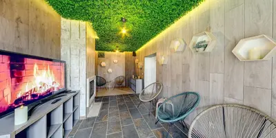a room with chairs and a flat screen tv at BOUTIQUE Hotel ENTRY E in Bansko