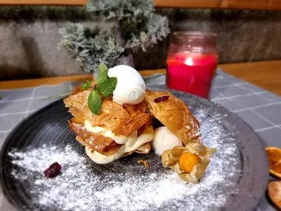 a piece of food on a plate with powdered sugar at BOUTIQUE Hotel ENTRY E in Bansko
