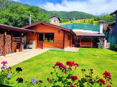 a house with a yard with flowers in front of it at Villa Boro in Beli Iskar