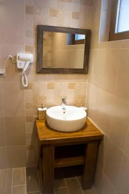 a bathroom with a white sink and a mirror at Villa Boro in Beli Iskar