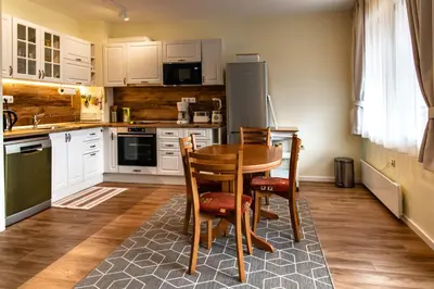 a kitchen with a table and chairs and a refrigerator at Bansko Ski Apartment in Bansko