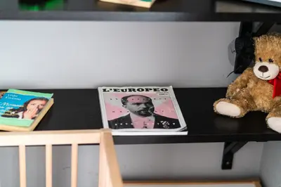 a teddy bear sitting on a shelf with a magazine at Modern Apartment 2 with Parking next to Bulgaria Mall in Sofia