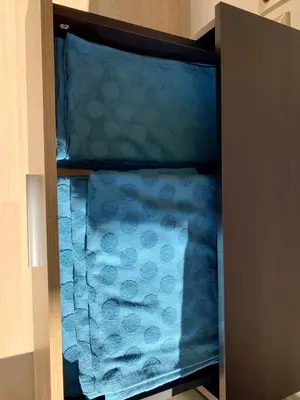 a cabinet filled with towels in a room at Premium Apartments Bansko in Bansko