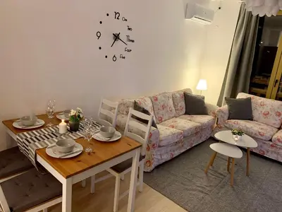 a living room with a couch and a table at Premium Apartments Bansko in Bansko