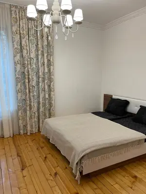 a bedroom with a bed and a chandelier at Parchevich 26 Apartment - 24h Self Check-in in Sofia
