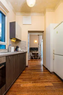 a kitchen with wooden flooring and a white refrigerator at 1BD Apartment with a Cute Balcony in Kapana by Flat Mаnager in Plovdiv