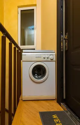 a washing machine with a mirror on top of it at 1BD Apartment with a Cute Balcony in Kapana by Flat Mаnager in Plovdiv
