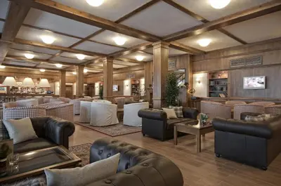 a large room with couches and chairs and a bar at Green Life, Bansko, private property in the complex Paradiso Verde, apartman C23 in Bansko
