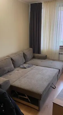 a large couch in a living room with a large window at Borovets Sequoia2 Apartment no 5 in Borovets