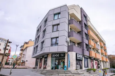 a tall building on a city street with stairs at Apartments Monik Sandanski in Sandanski