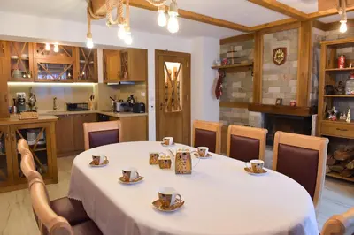 a dining room with a table with cups on it at Лукс апартамент in Bansko