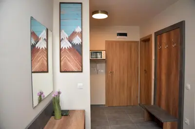 a hallway with a bench and a door in a house at Hashtag Studio Borovets in Borovets
