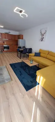 a living room with a yellow couch and a table at Apartments KaVi , Monastery 1 & 3, Grand Monastery,Pamporovo in Pamporovo