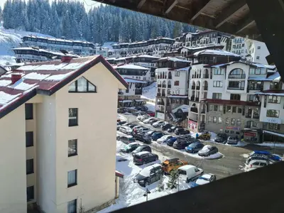 arial view of a city with cars parked in a parking lot at Apartments KaVi , Monastery 1 & 3, Grand Monastery,Pamporovo in Pamporovo