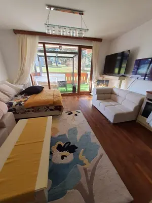 a living room with a couch and a table at Vintage studio at Pirin golf in Bansko
