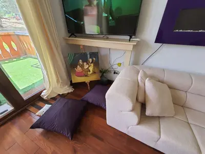 a living room with a couch and a flat screen tv at Vintage studio at Pirin golf in Bansko