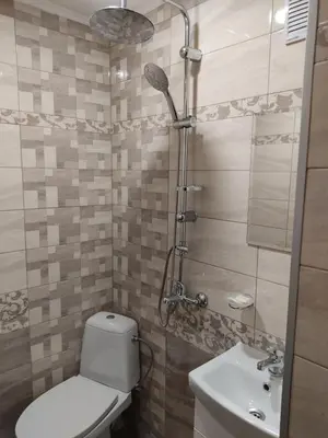 a bathroom with a toilet and a shower and a sink at Тороманова къща in Koprivshtitsa