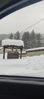 a table covered in snow on top of a roof at Тороманова къща in Koprivshtitsa