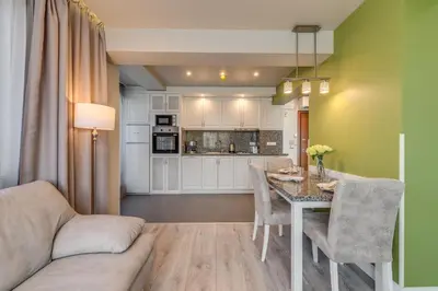 a kitchen and dining room with a table and chairs at R & R Apartments in Sofia