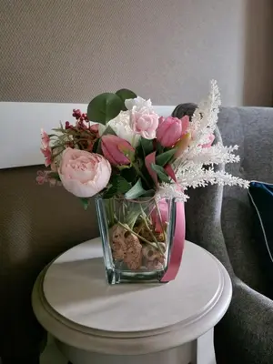 a vase filled with flowers sitting on a table at R & R Apartments in Sofia