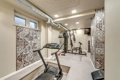 a gym with two treadmills and a treadmill at R & R Apartments in Sofia