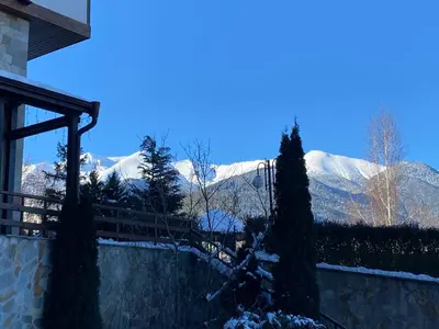a view of snow covered mountains from a house at Luxury private studio in Paradiso Verde in Bansko