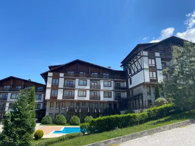 a large building with a pool in front of it at Luxury private studio in Paradiso Verde in Bansko
