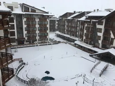 a courtyard covered in snow in a building at Bansko Belvedere Apartament in Bansko